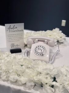 White Rotary Style Phone With Flowers Around it.